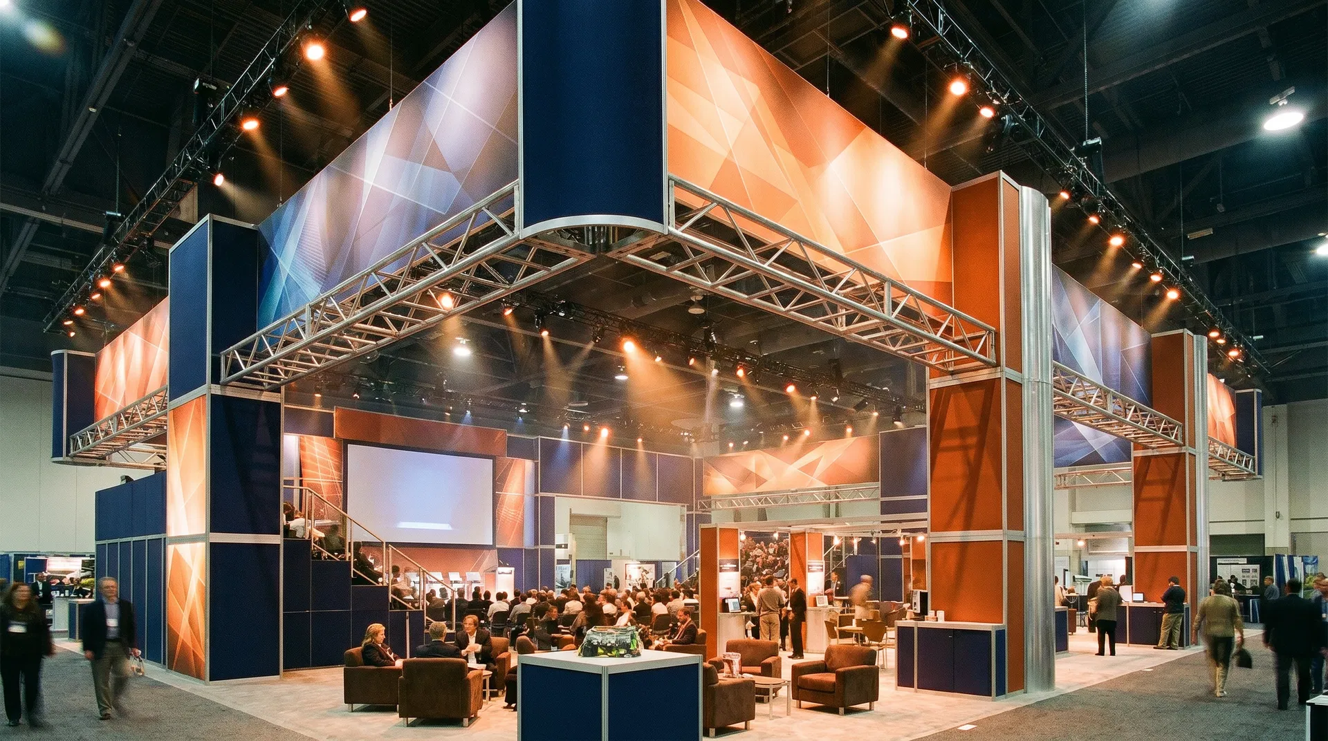 Large 20x30 trade show exhibit rental featuring modular aluminum framework, overhead rigging, and strategic zoning for traffic flow.